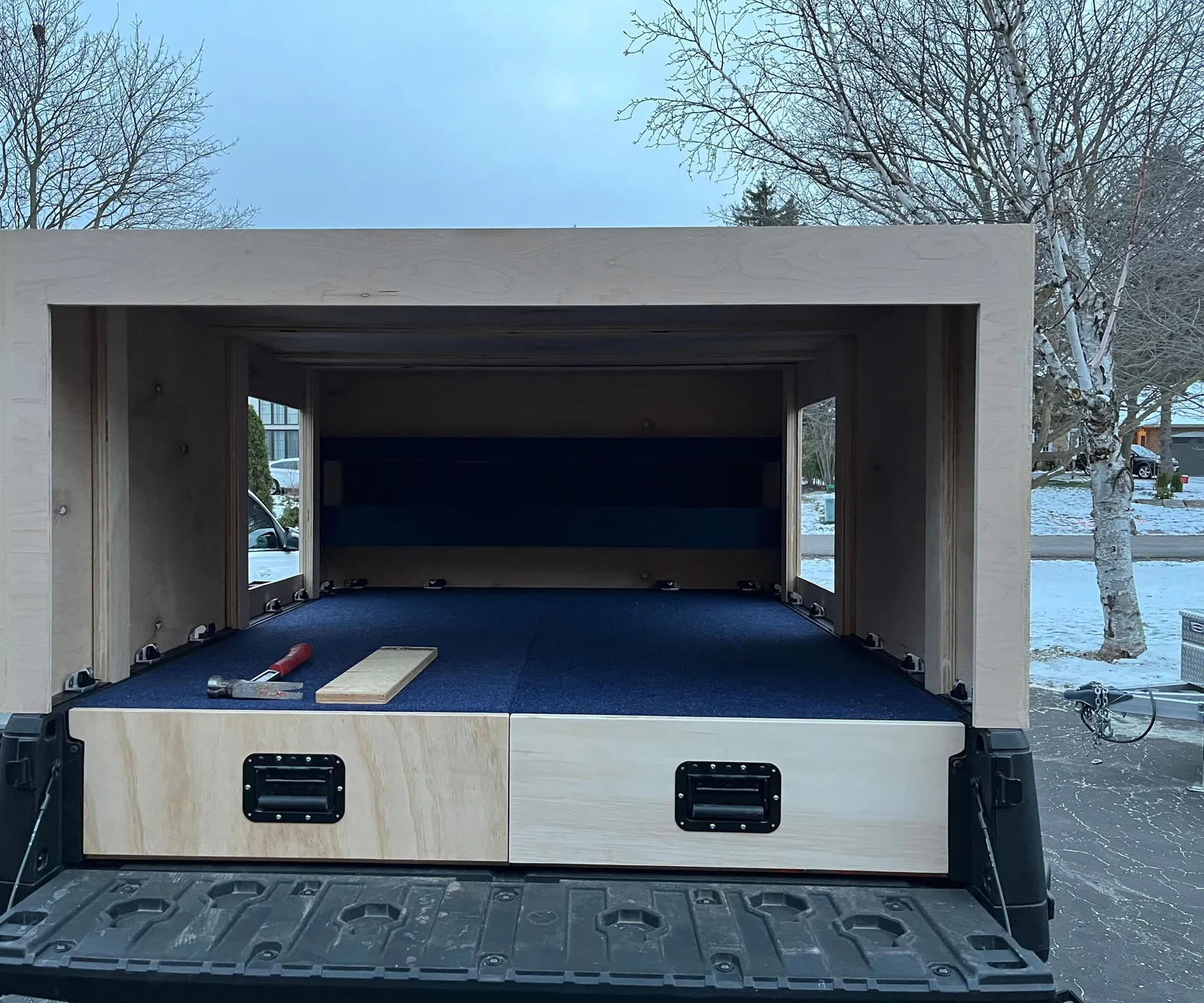 The rear of the cabin on the UTV bed, with carpeted drawers.
